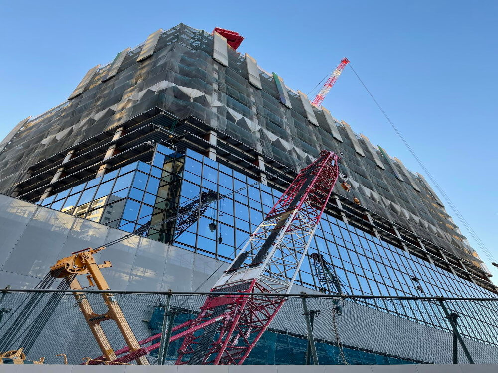 low-angle-view-crane-by-building-against-clear-sky