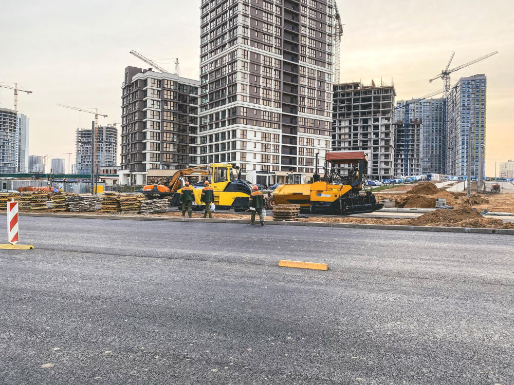 workers-orange-helmets-protective-uniforms-are-construction-site-nearby-construction